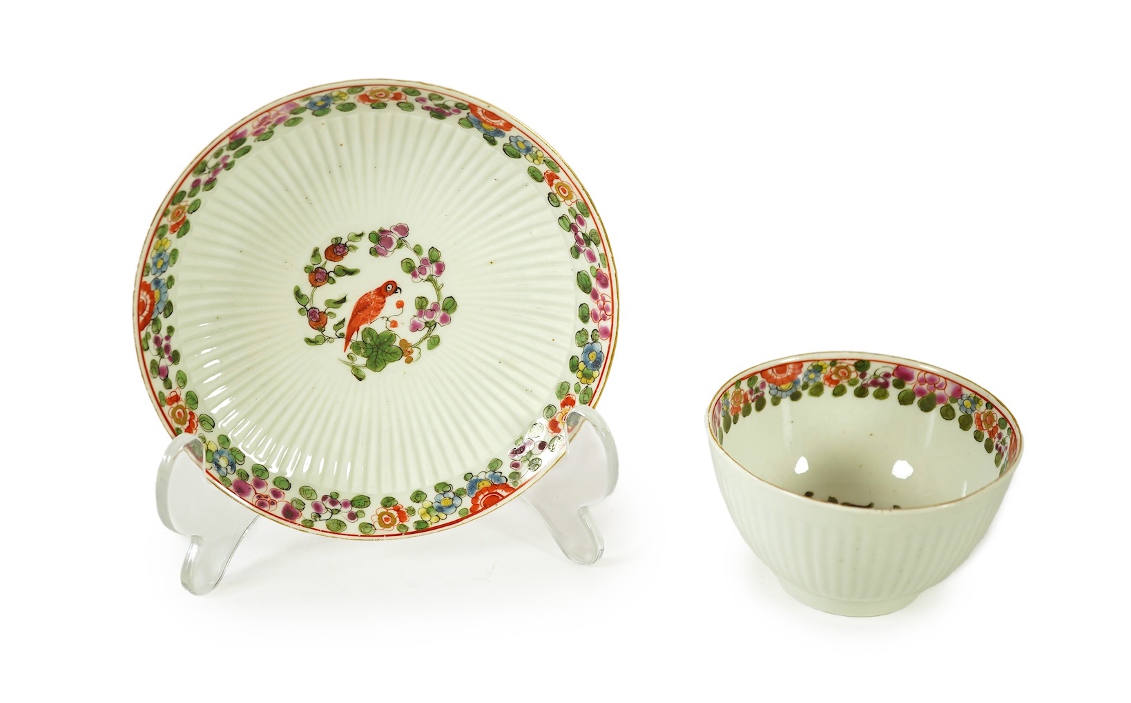 A Worcester Old Worcester Parrot pattern tea bowl and saucer, c.1765-68, saucer 11.5cm in diameter